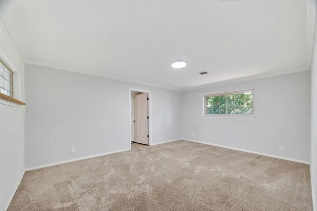 an empty room with a empty space and windows