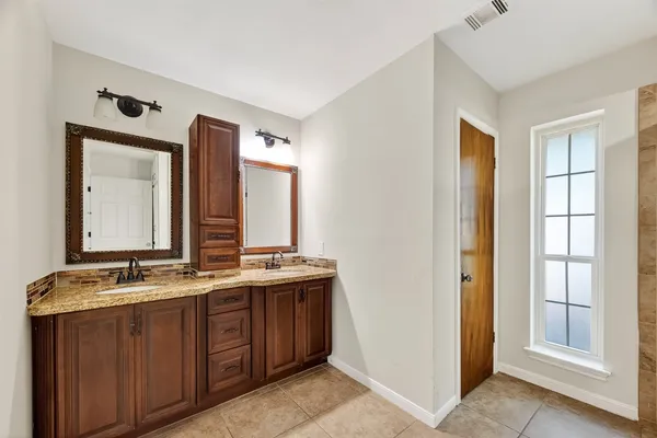 a bathroom with a glass shower door