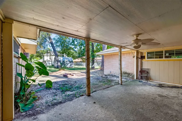 a backyard of a house with a table and chairs