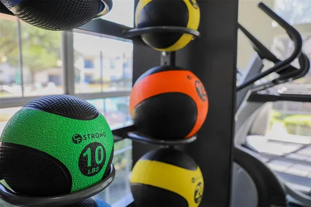 a room with gym equipment and windows