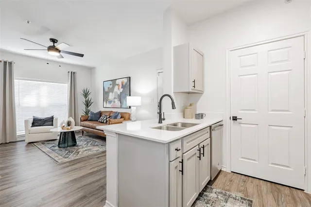 a bed sitting in a bedroom next to a window and a lamp