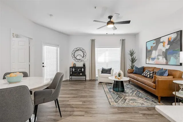 a living room with furniture and wooden floor