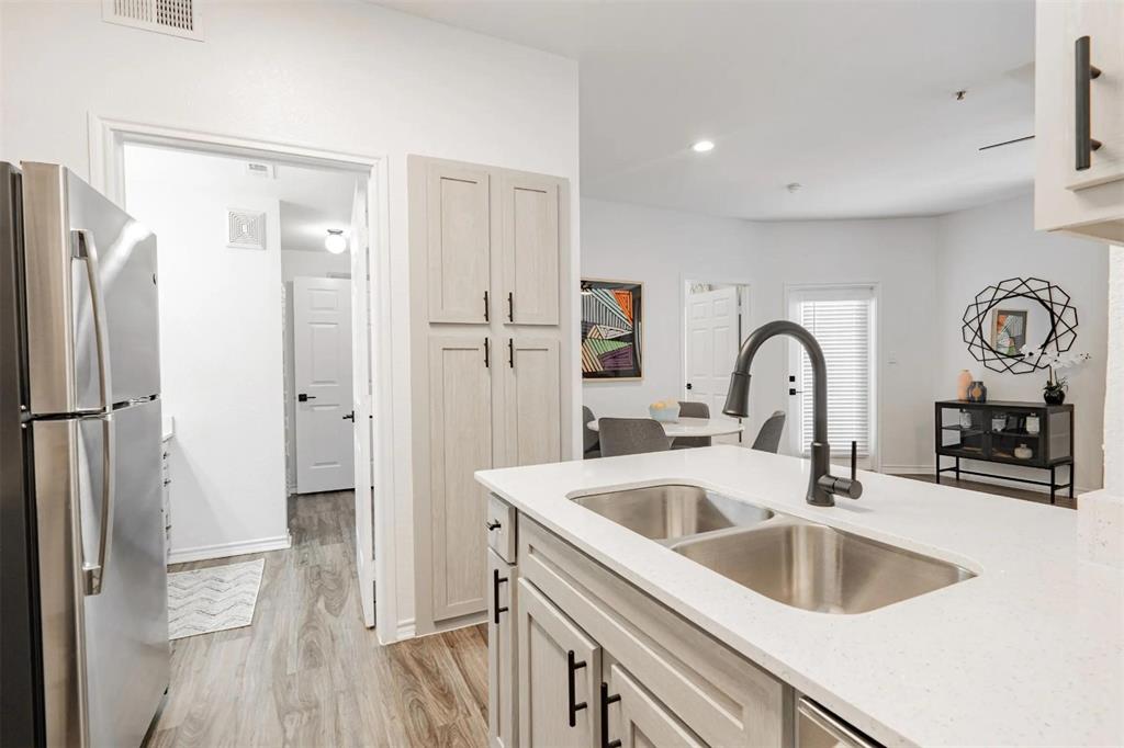1600 North 9th Street, Unit A1R Midlothian, TX 76065 - Photo 24 of 40 a kitchen with a refrigerator sink and cabinets
