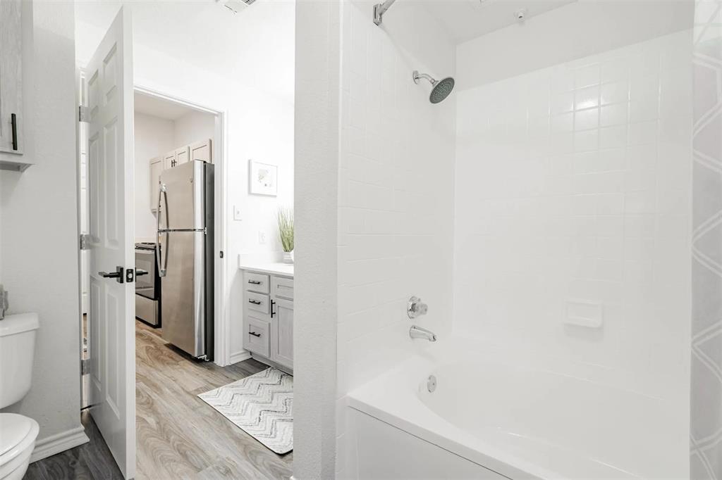 1600 North 9th Street, Unit A1R Midlothian, TX 76065 - Photo 28 of 40 a bathroom with a tub sink and toilet