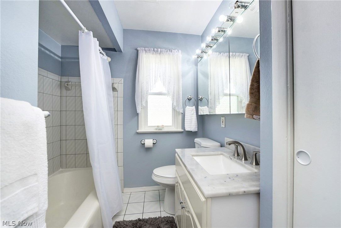 21399 Mastick Road Cleveland, OH 44126 - Photo 38 of 47 Full bathroom featuring shower / bathtub combination with curtain, tile flooring, vanity, and toilet