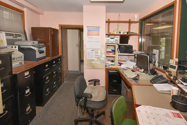 a view of a workspace with furniture