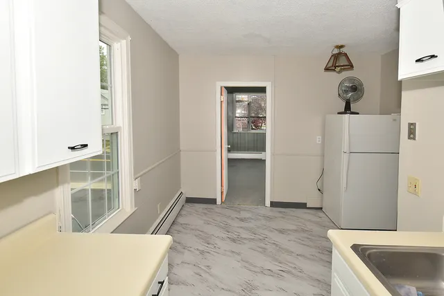 a kitchen with a refrigerator and a sink