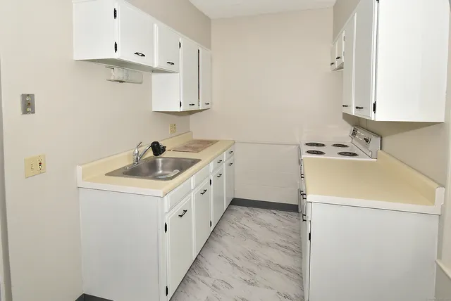 a utility room with sink dryer and washer