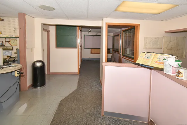 a view of a hallway with furniture and front door