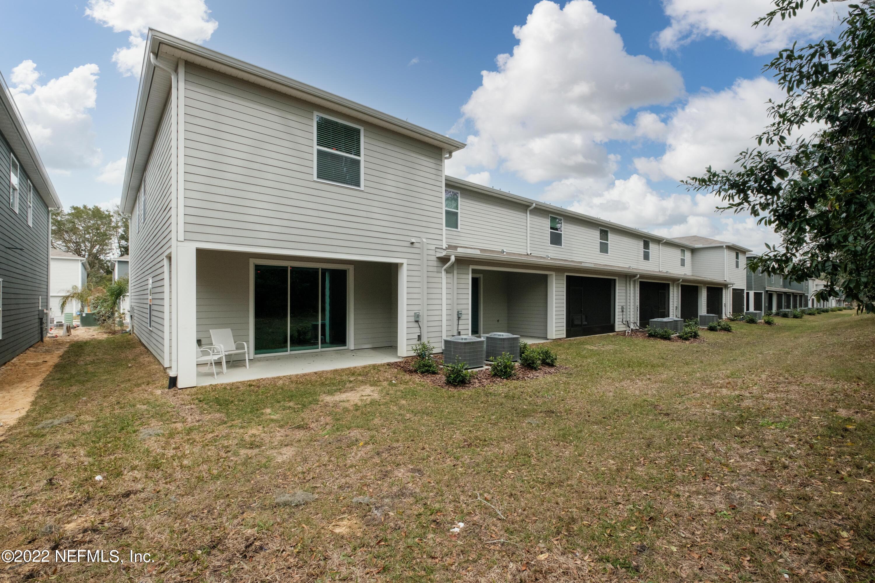 13803 Northwest 9th Road Newberry, FL 32669 - Photo 16 of 21 a front view of house with yard and trees in the background