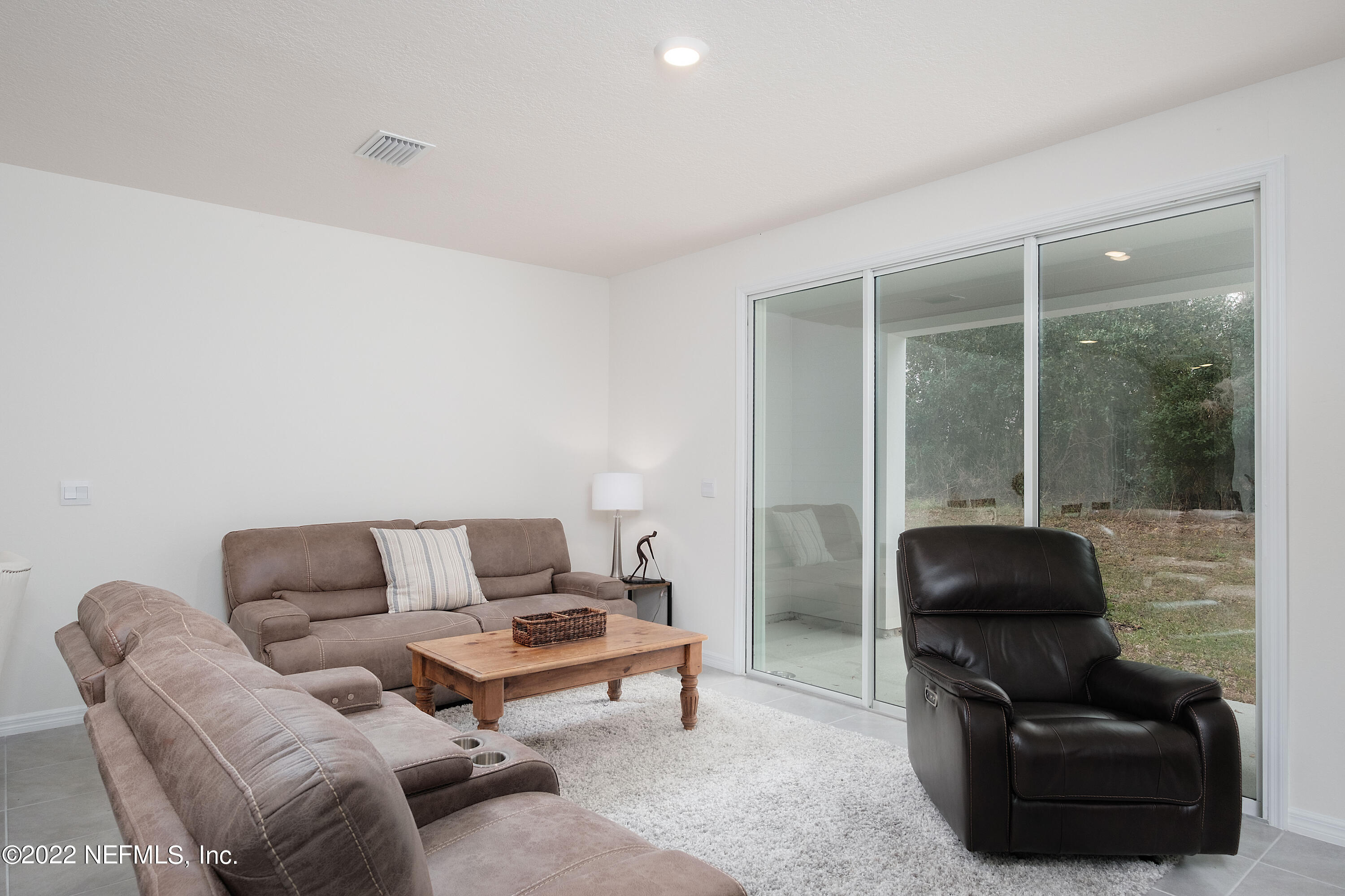 13803 Northwest 9th Road Newberry, FL 32669 - Photo 6 of 21 a living room with furniture and a air conditioner vent
