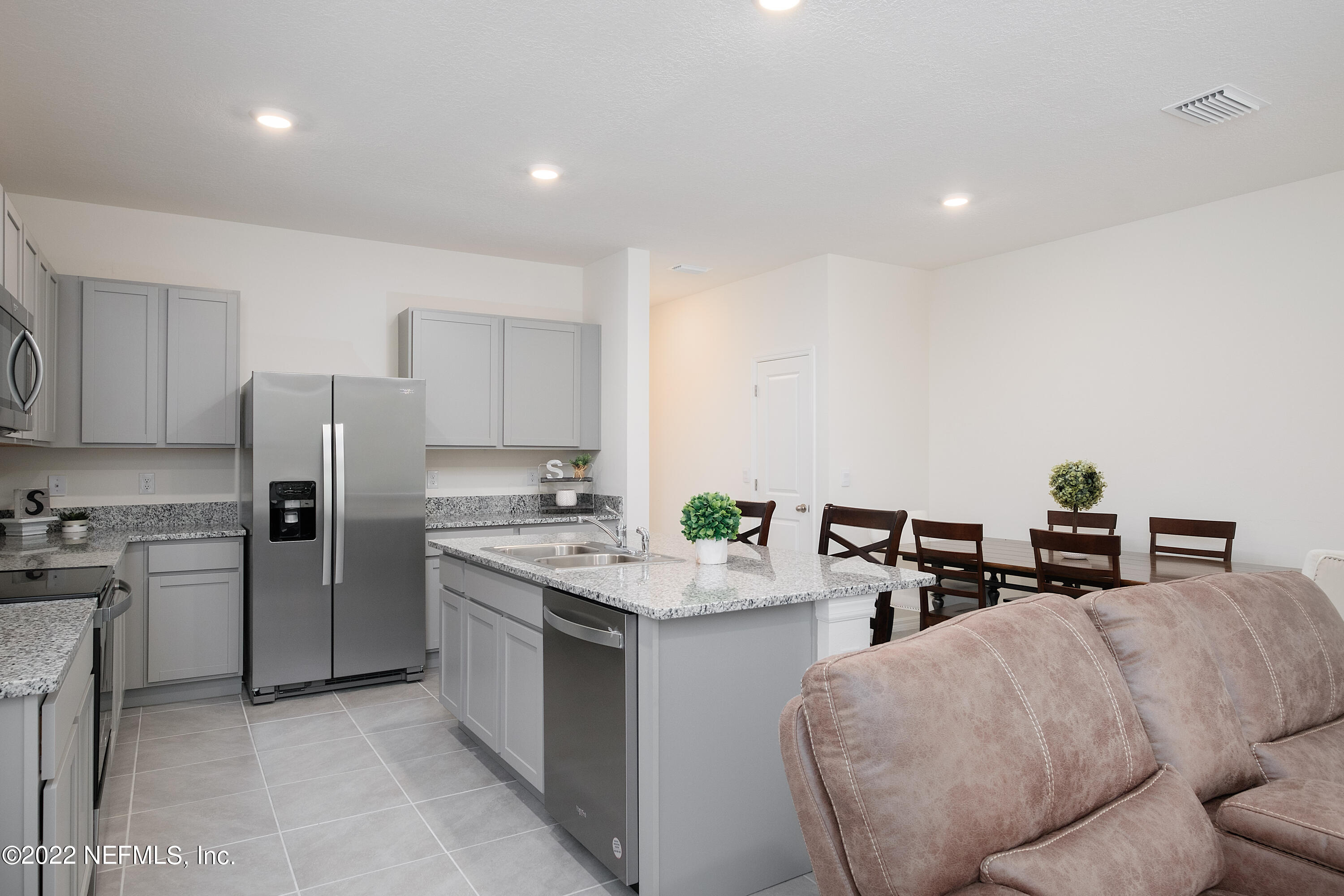 13803 Northwest 9th Road Newberry, FL 32669 - Photo 7 of 21 a kitchen with stainless steel appliances granite countertop a sink a stove a chimney a refrigerator and cabinets