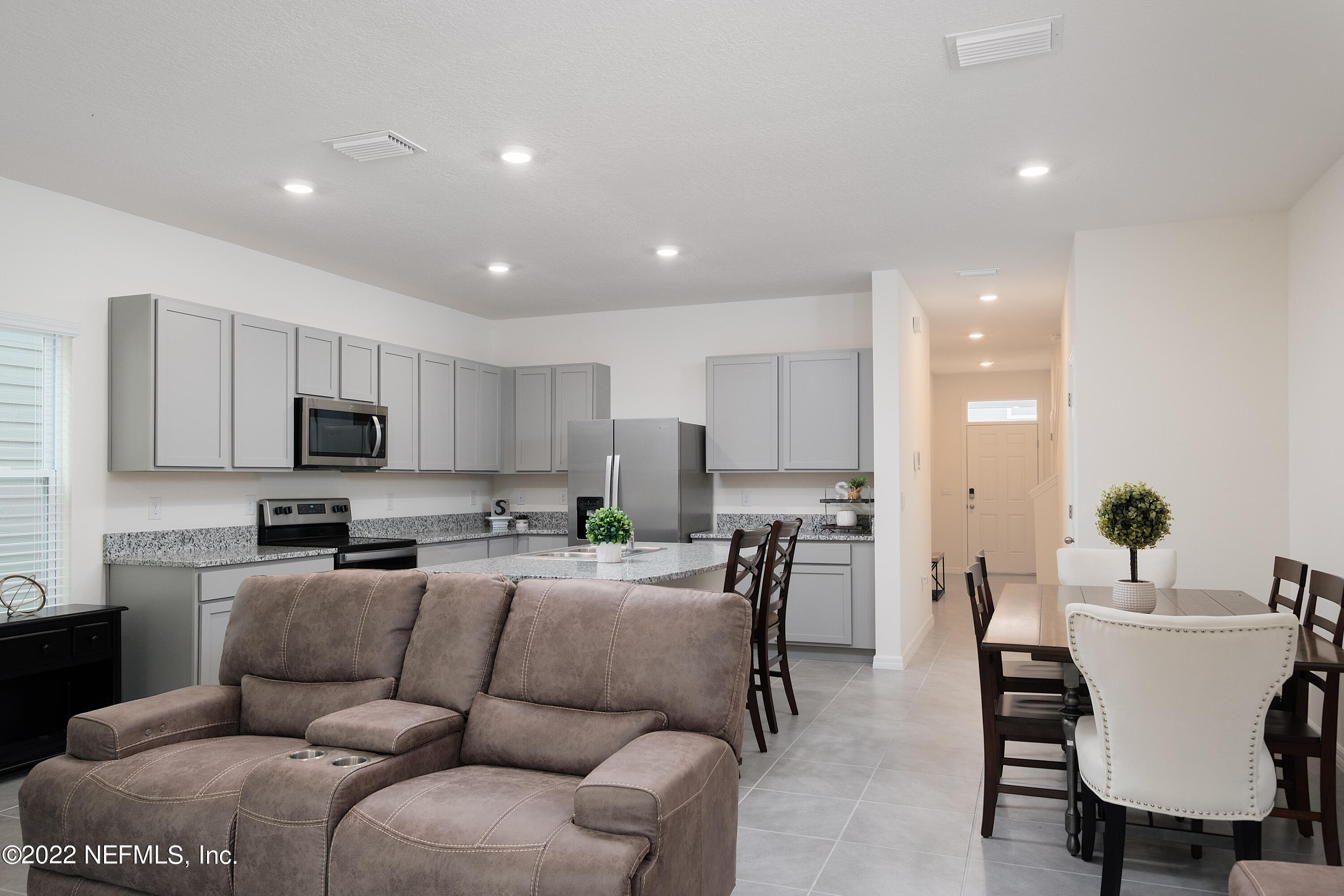 13803 Northwest 9th Road Newberry, FL 32669 - Photo 8 of 21 a living room with furniture a kitchen view and a sink