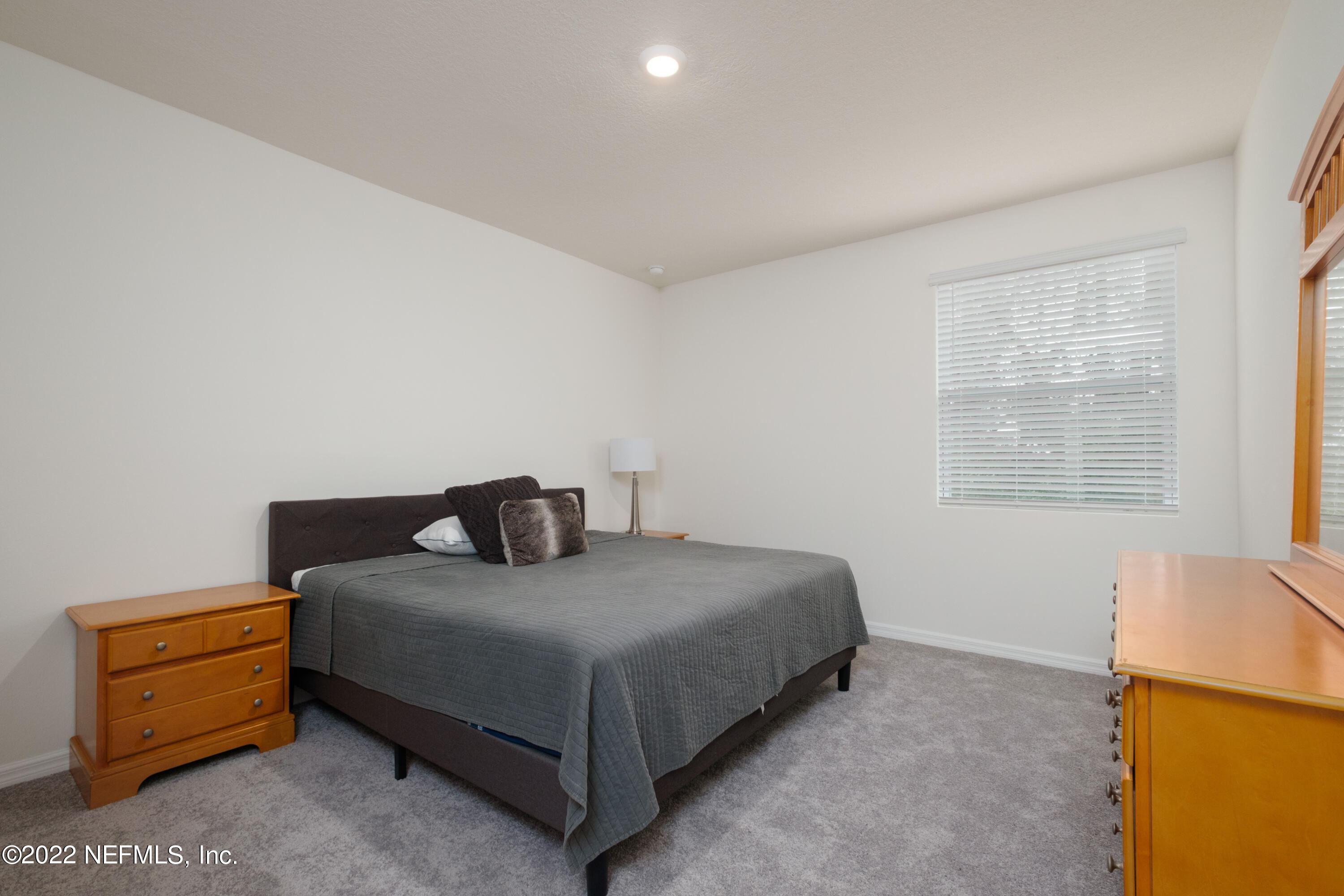 13803 Northwest 9th Road Newberry, FL 32669 - Photo 9 of 21 a bedroom with a bed and a dresser