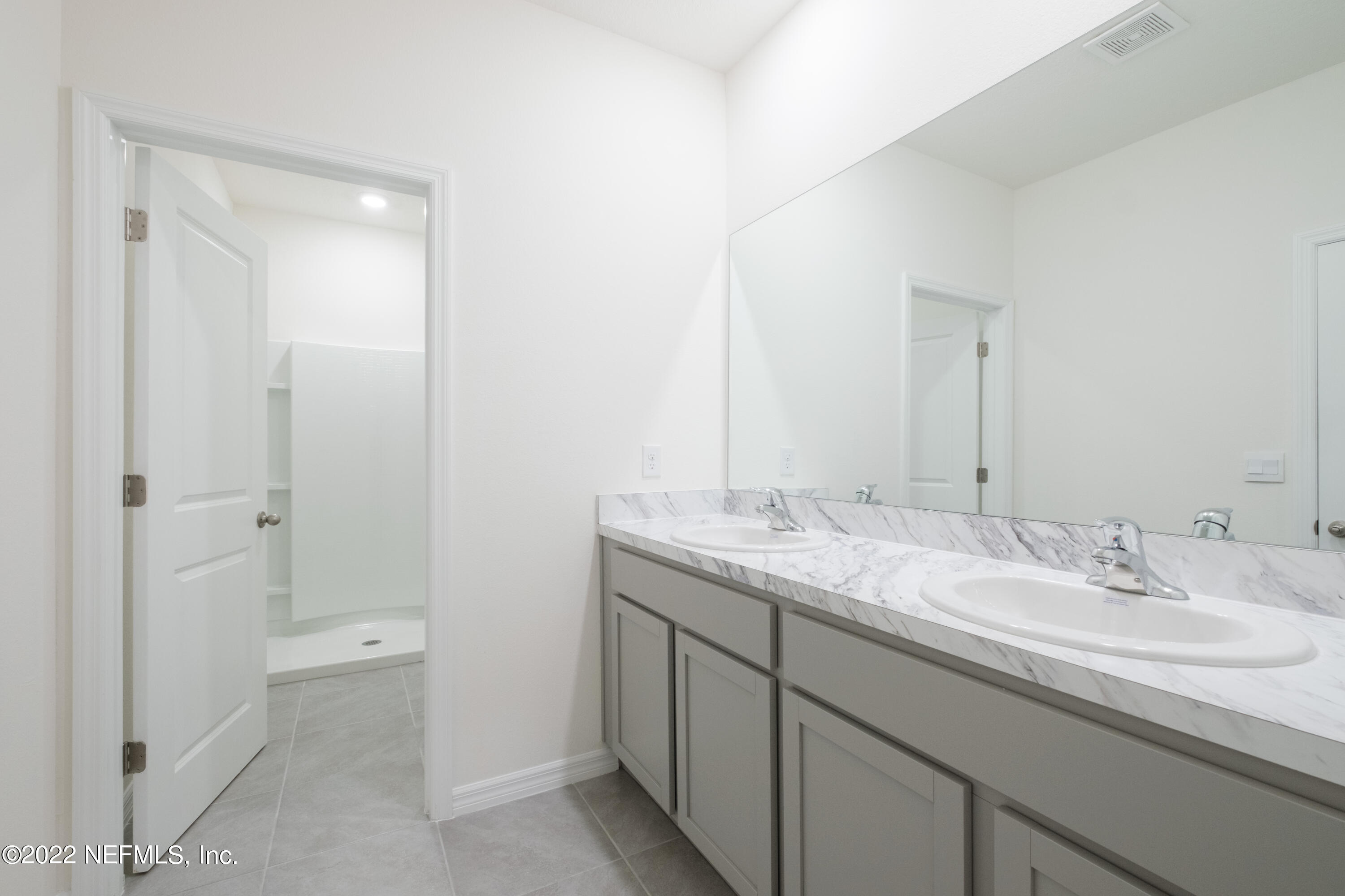 13803 Northwest 9th Road Newberry, FL 32669 - Photo 10 of 21 a bathroom with a granite countertop sink and a mirror