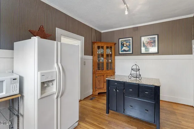 a kitchen with stainless steel appliances a refrigerator and a stove