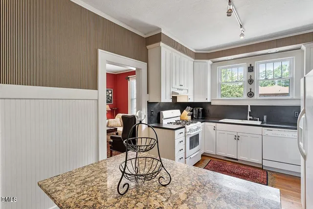 a kitchen with a sink cabinets and window