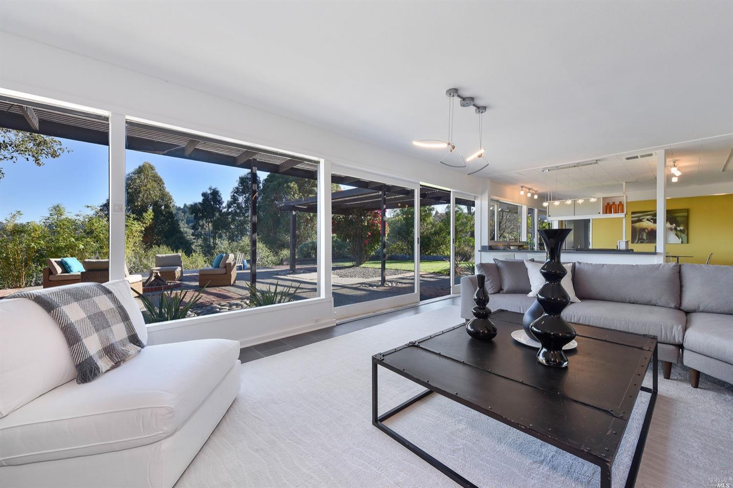 a living room with furniture and large windows