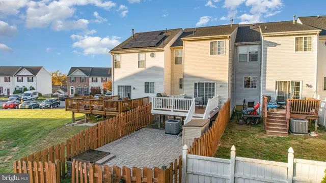 an aerial view of residential houses with outdoor space and swimming pool