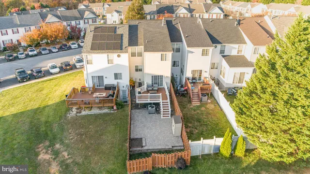 a view of a tennis ground with large trees