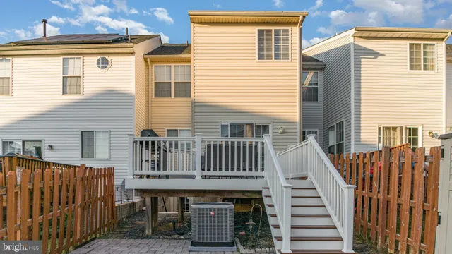 a view of a house with wooden deck front door