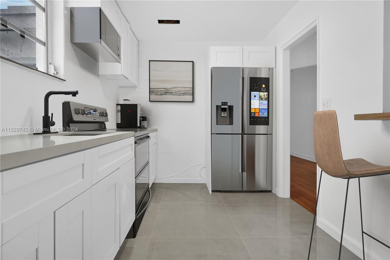 1886 Southwest 16th Terrace Miami, FL 33145 - Photo 8 of 14 a kitchen with stainless steel appliances a refrigerator sink and microwave