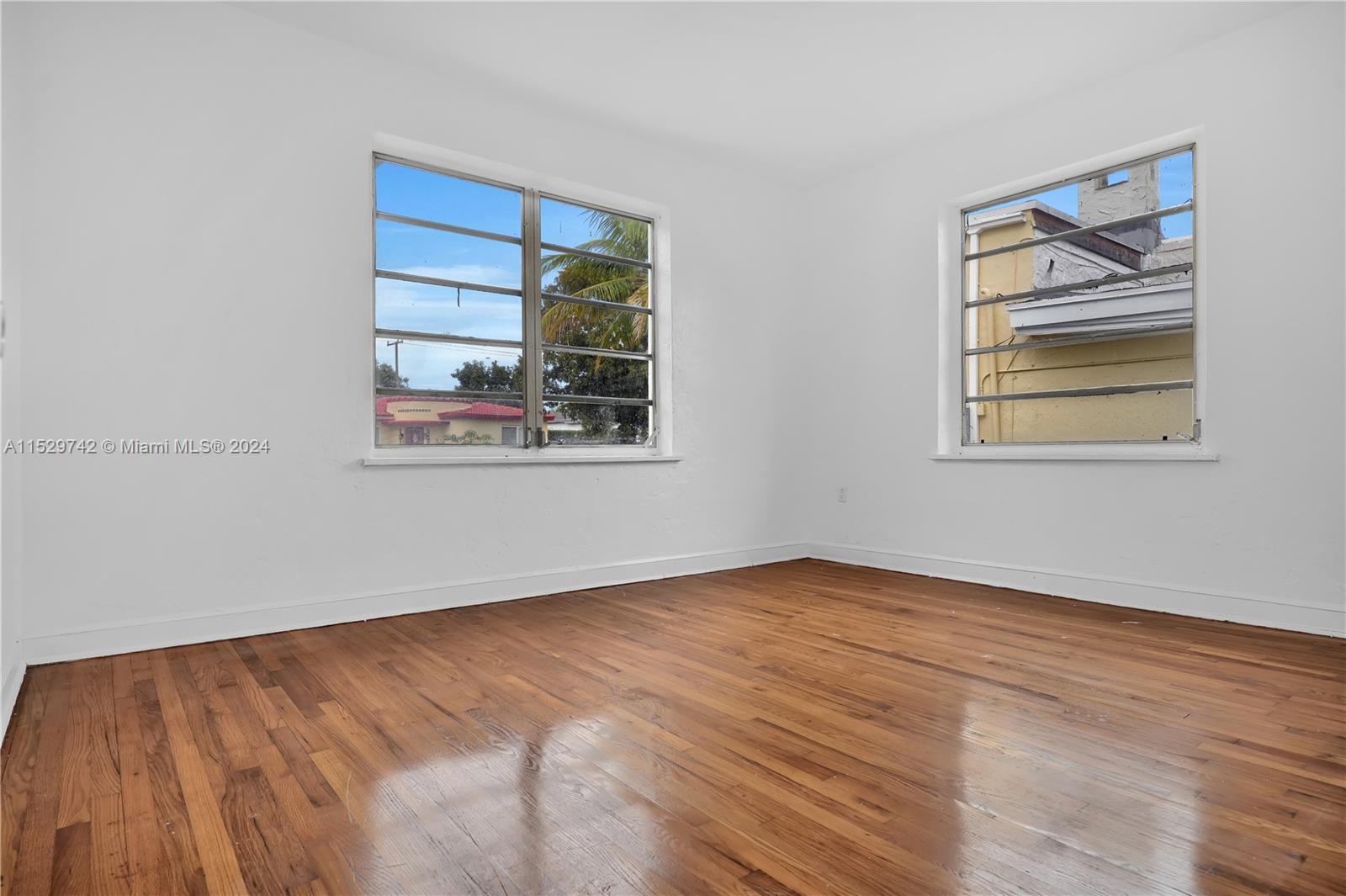 1886 Southwest 16th Terrace Miami, FL 33145 - Photo 10 of 14 a view of empty room with wooden floor and fan
