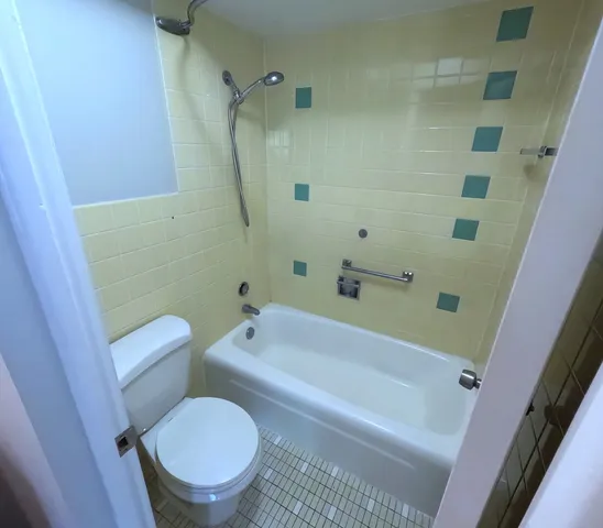 a view of a bathroom with a tub and toilet