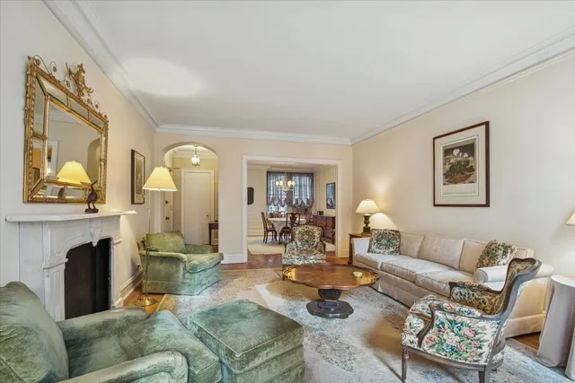 a living room with fireplace furniture and a wooden floor