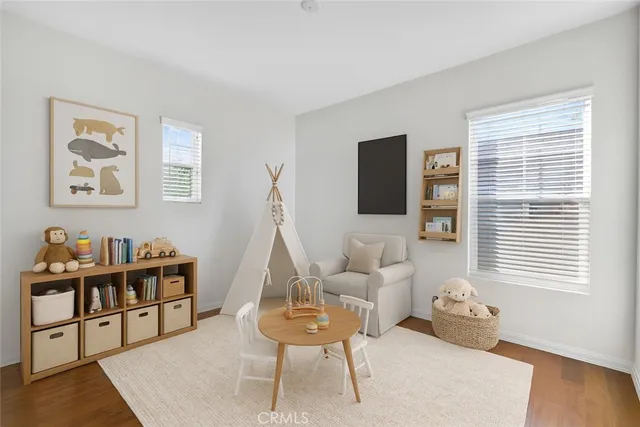 a bedroom with a bed and a potted plant