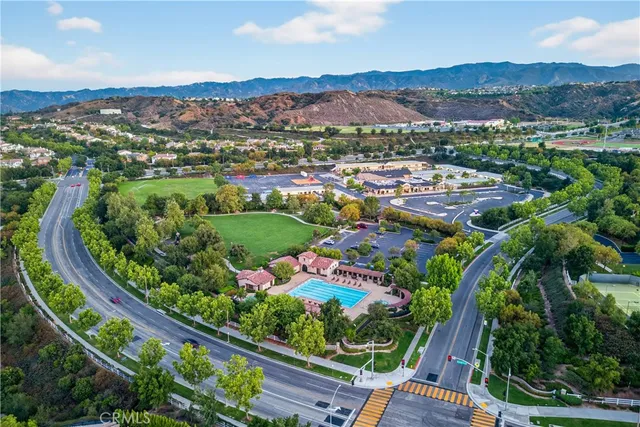 an aerial view of a house with a garden and mountain view