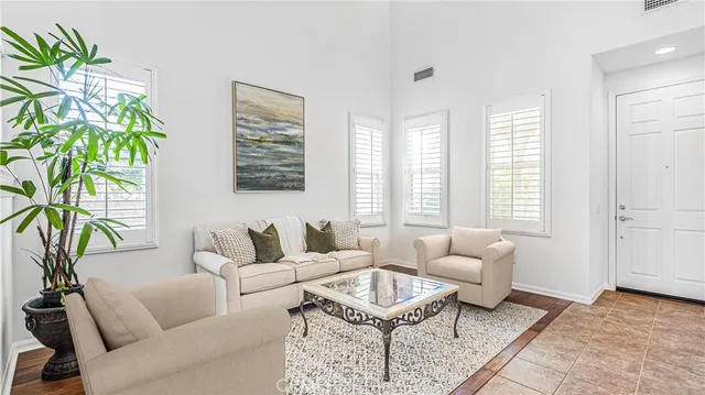 a living room with furniture and a potted plant