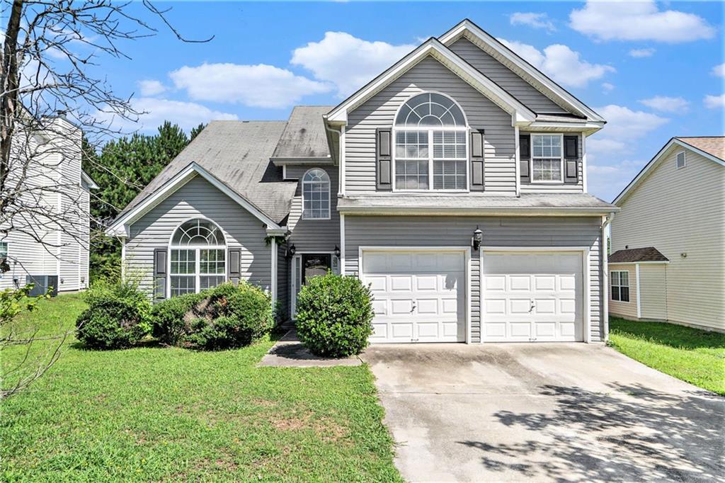 7812 Bell Tower Lane Union City, GA 30213 - Photo 1 of 1 a front view of a house with a yard and garage