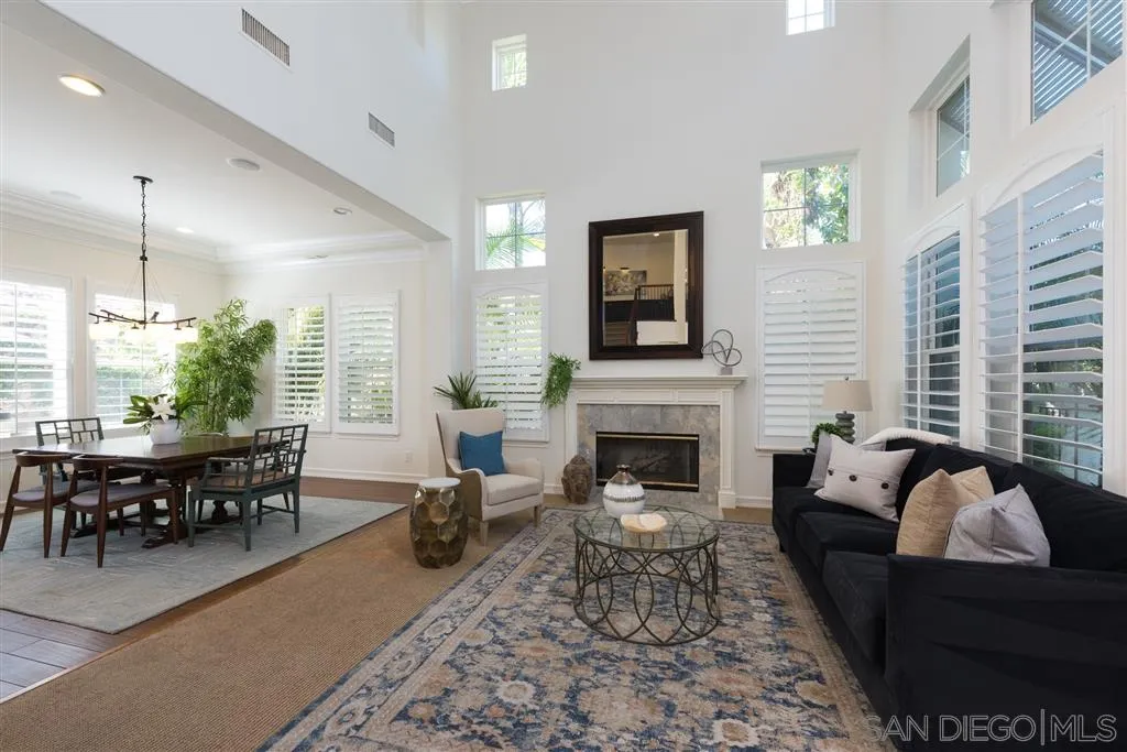 11692 Eastfield Road Poway, CA 92064 - Photo 4 of 25 a living room with furniture dining table and a fireplace
