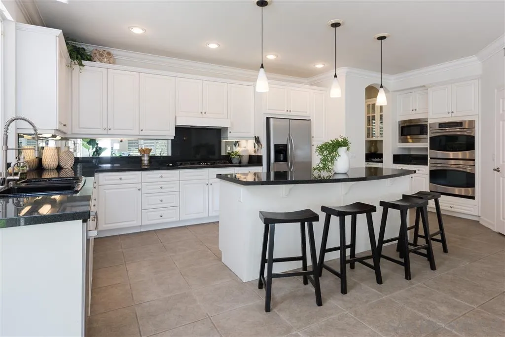 11692 Eastfield Road Poway, CA 92064 - Photo 7 of 25 a kitchen with kitchen island granite countertop a table and chairs in it