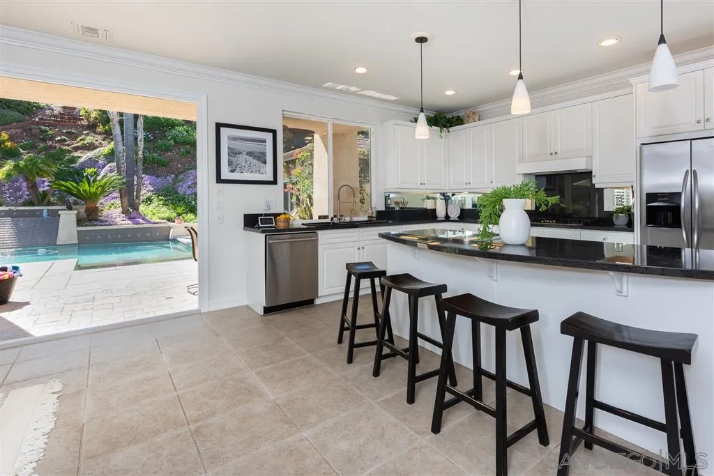 11692 Eastfield Road Poway, CA 92064 - Photo 8 of 25 a kitchen with sink a microwave and chairs