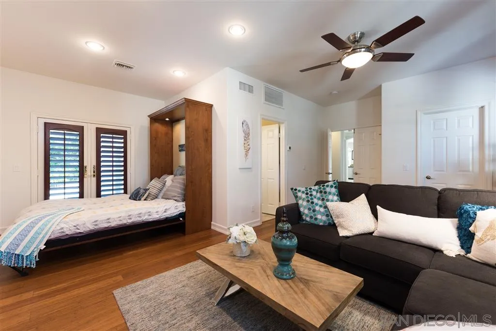 11692 Eastfield Road Poway, CA 92064 - Photo 10 of 25 a bedroom with a bed a couch and a dresser with wooden floor