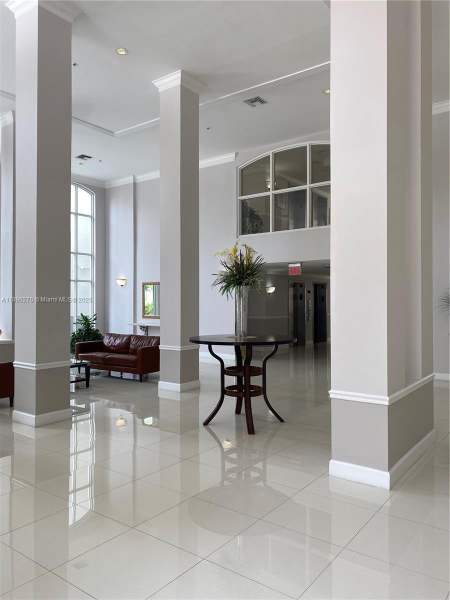 9725 Northwest 52nd Street, Unit 522 Doral, FL 33178 - Photo 15 of 17 a living room with furniture and a potted plant