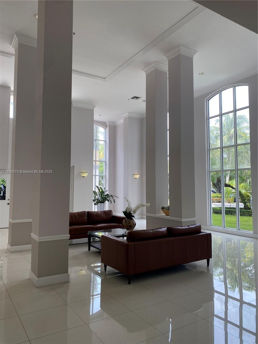9725 Northwest 52nd Street, Unit 522 Doral, FL 33178 - Photo 16 of 17 a living room with furniture and a large window