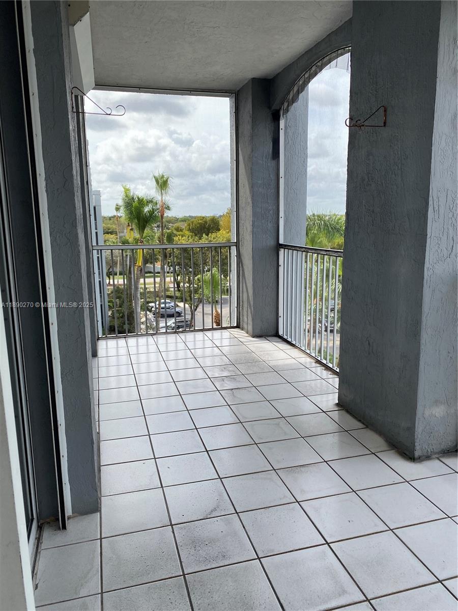 9725 Northwest 52nd Street, Unit 522 Doral, FL 33178 - Photo 3 of 17 a view of empty room with wooden floor and fan