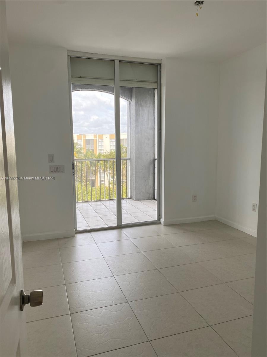 9725 Northwest 52nd Street, Unit 522 Doral, FL 33178 - Photo 5 of 17 a view of an empty room with a window