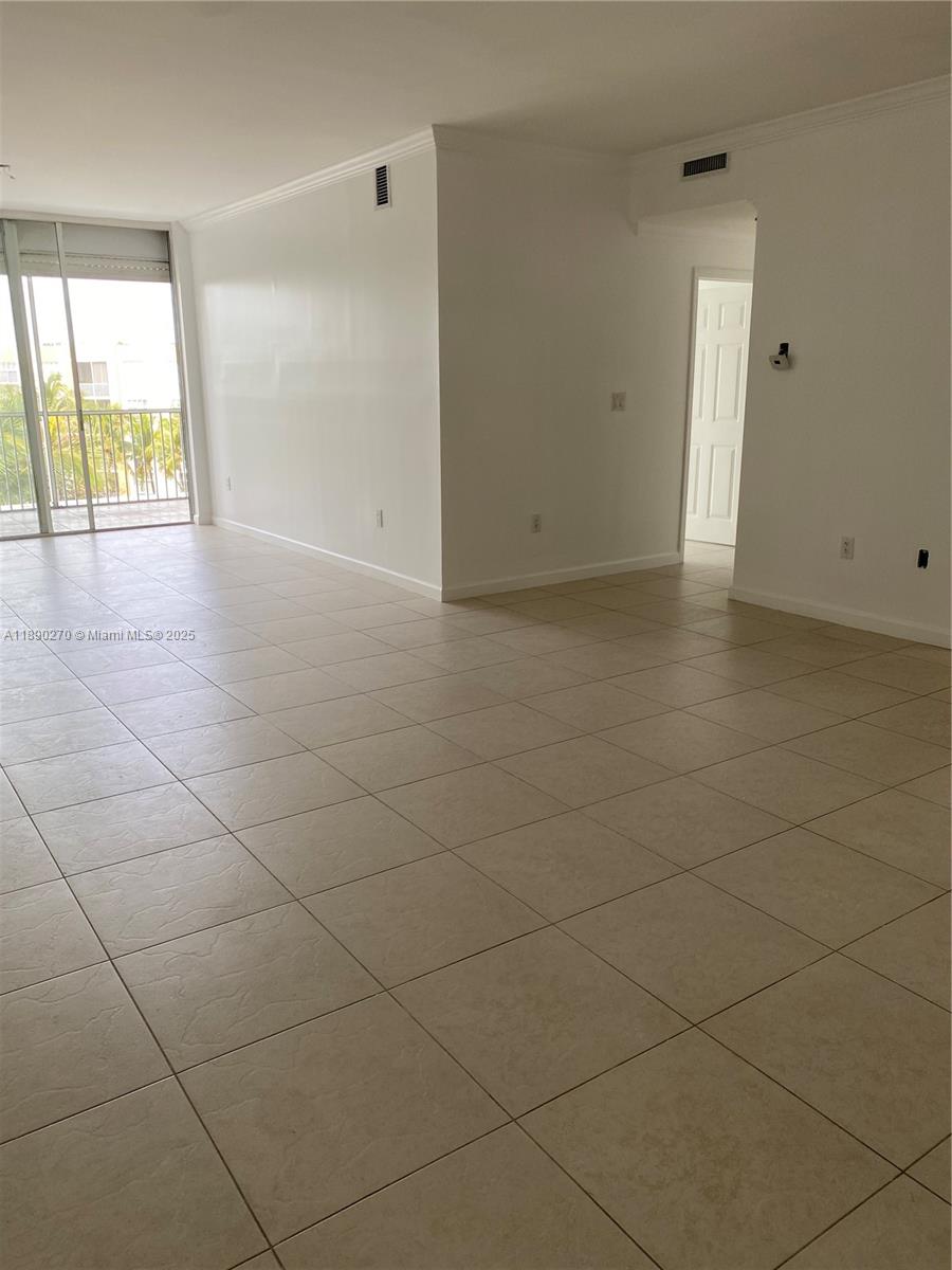 9725 Northwest 52nd Street, Unit 522 Doral, FL 33178 - Photo 7 of 17 wooden floor in an empty room with a window