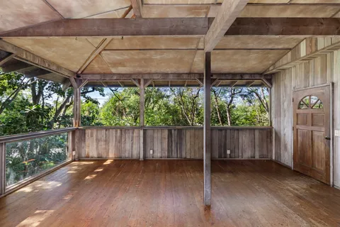 a view of a patio with table and chairs and wooden floor