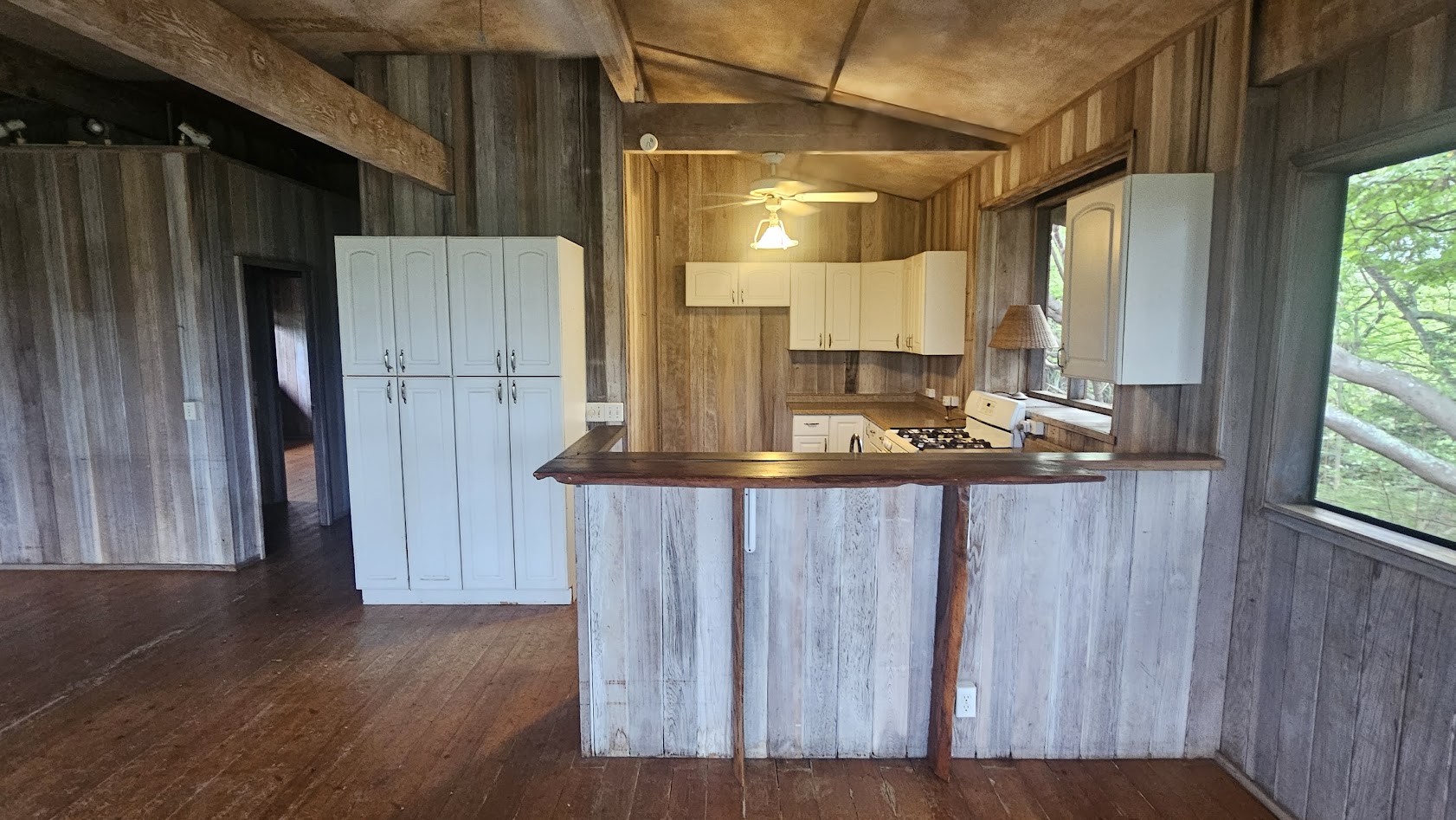 82-6284 Puuhonua Road Captain Cook, HI 96704 - Photo 9 of 30 a kitchen with a refrigerator and wooden cabinets