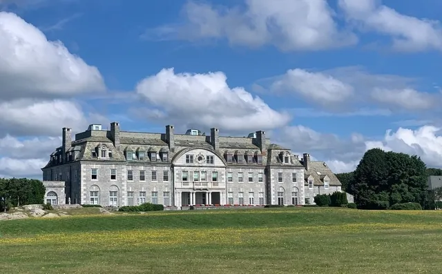 a view of building with yard in front of it