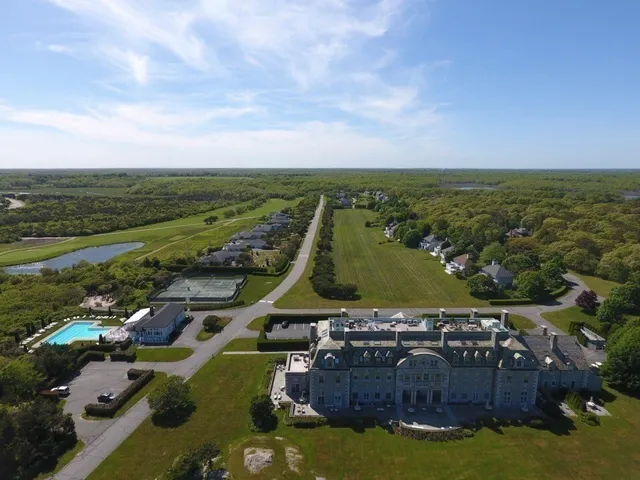a view of a city with lawn chairs and large tree