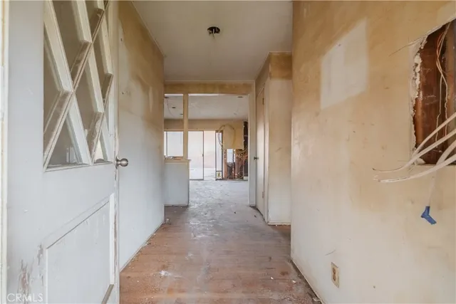 a view of a hallway with a white walls and a white door