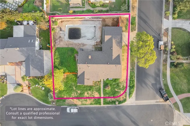 an aerial view of a house with a yard and potted plants