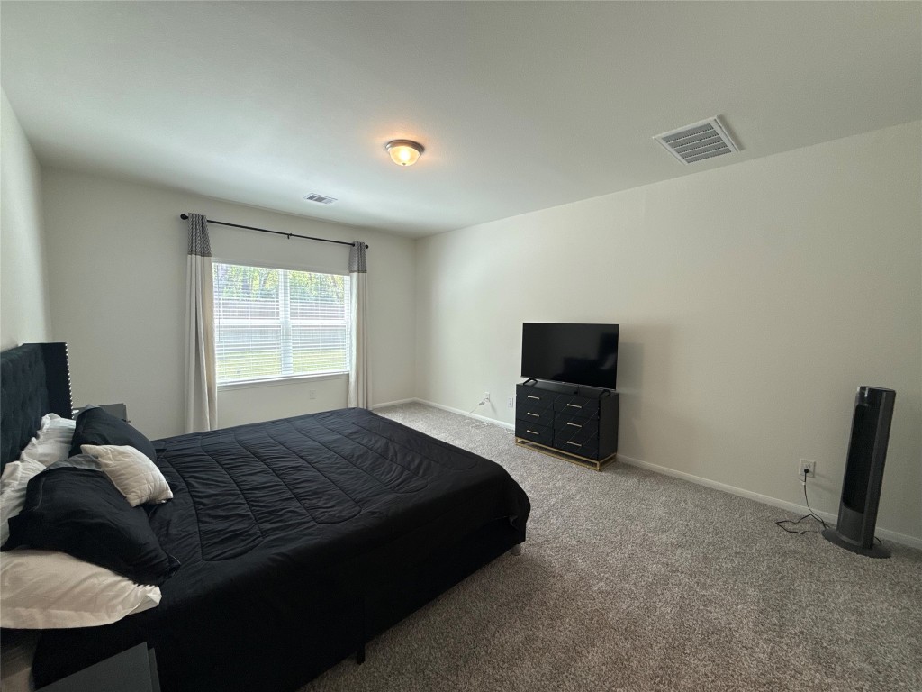 527 Baobab Way Crosby, TX 77532 - Photo 24 of 50 a bedroom with a bed and a television