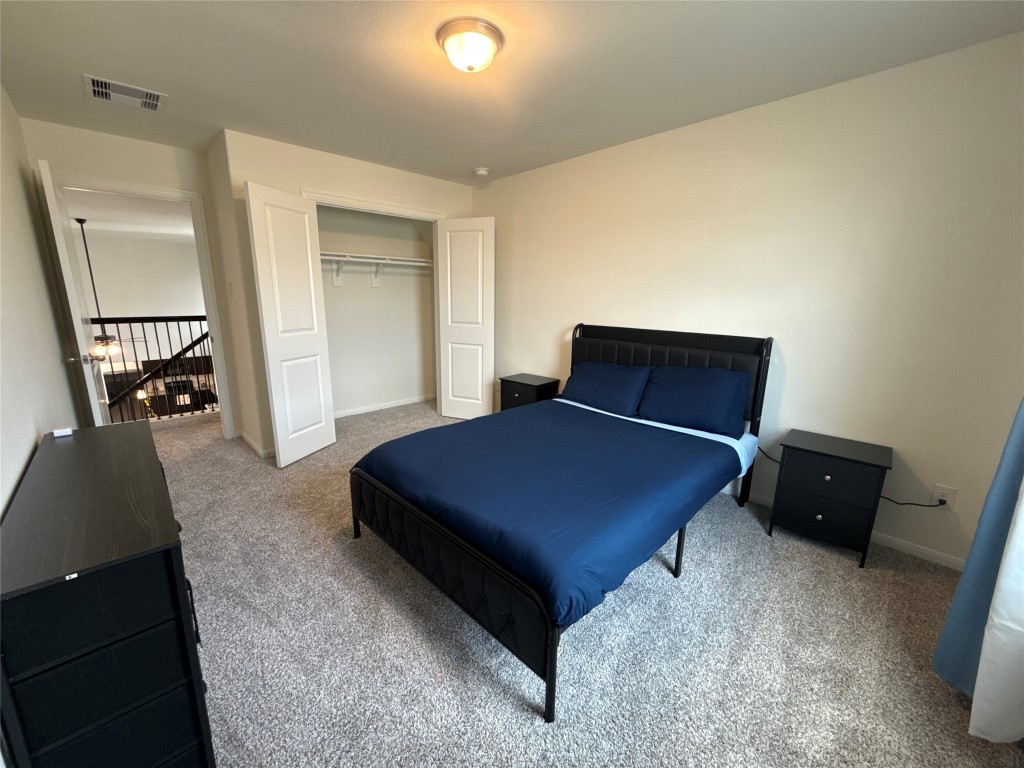 527 Baobab Way Crosby, TX 77532 - Photo 31 of 50 a bedroom with a bed and wooden floor